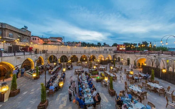 Outdoor dining area in a historic courtyard during Turkish cuisine tour in Southeastern Turkey.