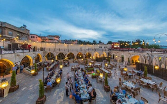 Outdoor dining area in a historic courtyard during Turkish cuisine tour in Southeastern Turkey.