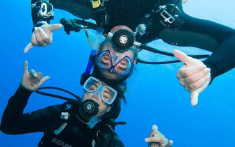 Scuba divers underwater in Sharm El Sheikh during a professional diving adventure.