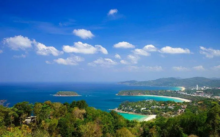 Phuket coastline view with lush greenery and blue ocean, part of the Private Island Highlights & Big Buddha Tour.