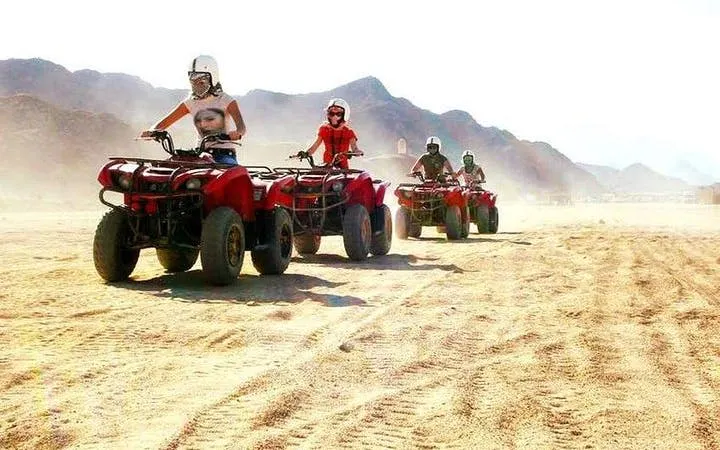 Quad biking tour in Hurghada desert with mountains in the background.
