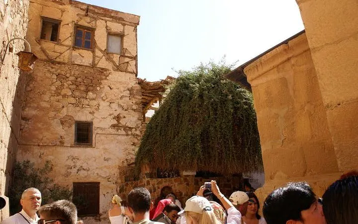 Visitors exploring Saint Catherine Monastery courtyard during guided tour from Sharm El Sheikh.