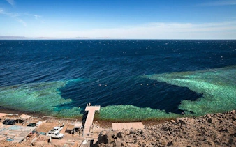 Blue Hole Canyon view with clear waters and a dock, Sharm El Sheikh.