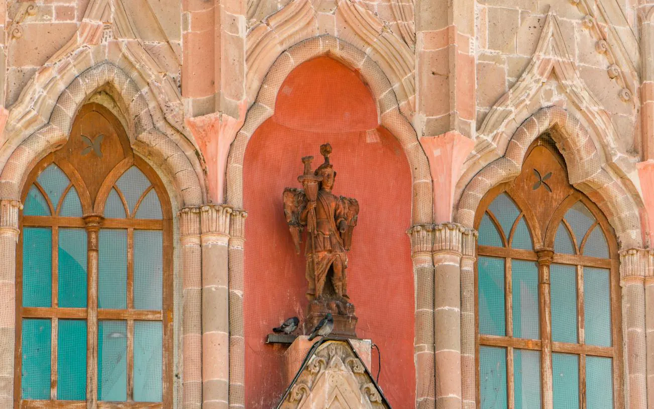 Facade detail of Parroquia de San Miguel Arcángel with statue, San Miguel de Allende, Mexico.