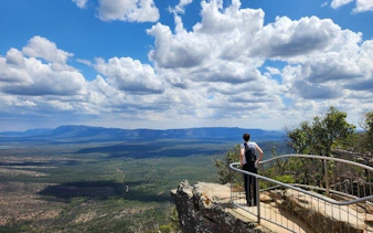 Hiker overlooking vast landscape at Grampians National Park during small-group tour.