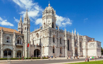 Jerónimos Monastery in Lisbon on a sunny day, part of a private historical city tour.