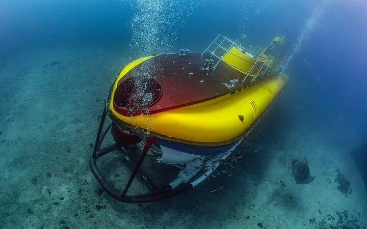 Submarine exploring underwater near Tenerife with Los Gigantes pickup.