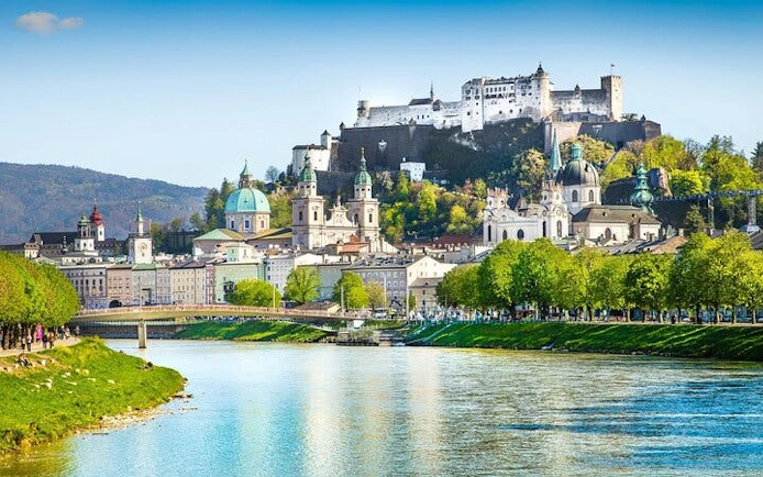 Salzburg cityscape with Hohensalzburg Fortress and Salzach River.