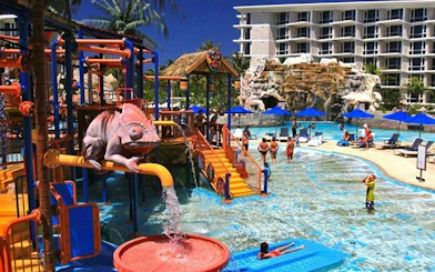 Children playing at Splash Jungle Water Park in Phuket with slides and water features.