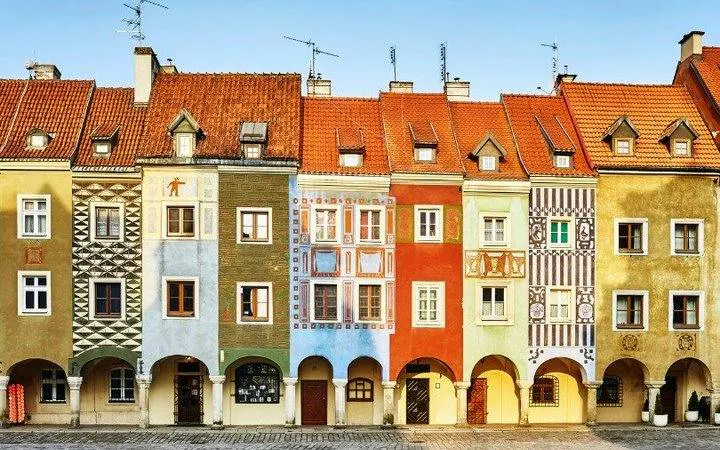 Colorful historic buildings in Poznan's Old Market Square, featured in a self-guided audio tour.