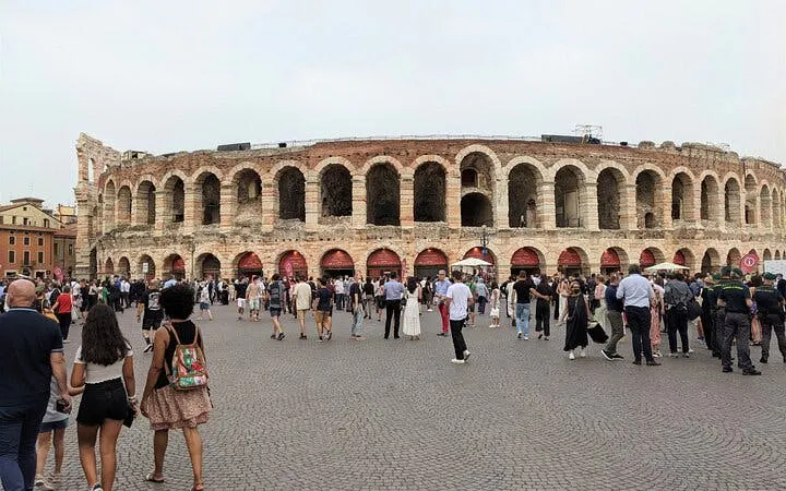Arena di Verona with visitors, Italy, part of guided city tour and opera ticket experience.