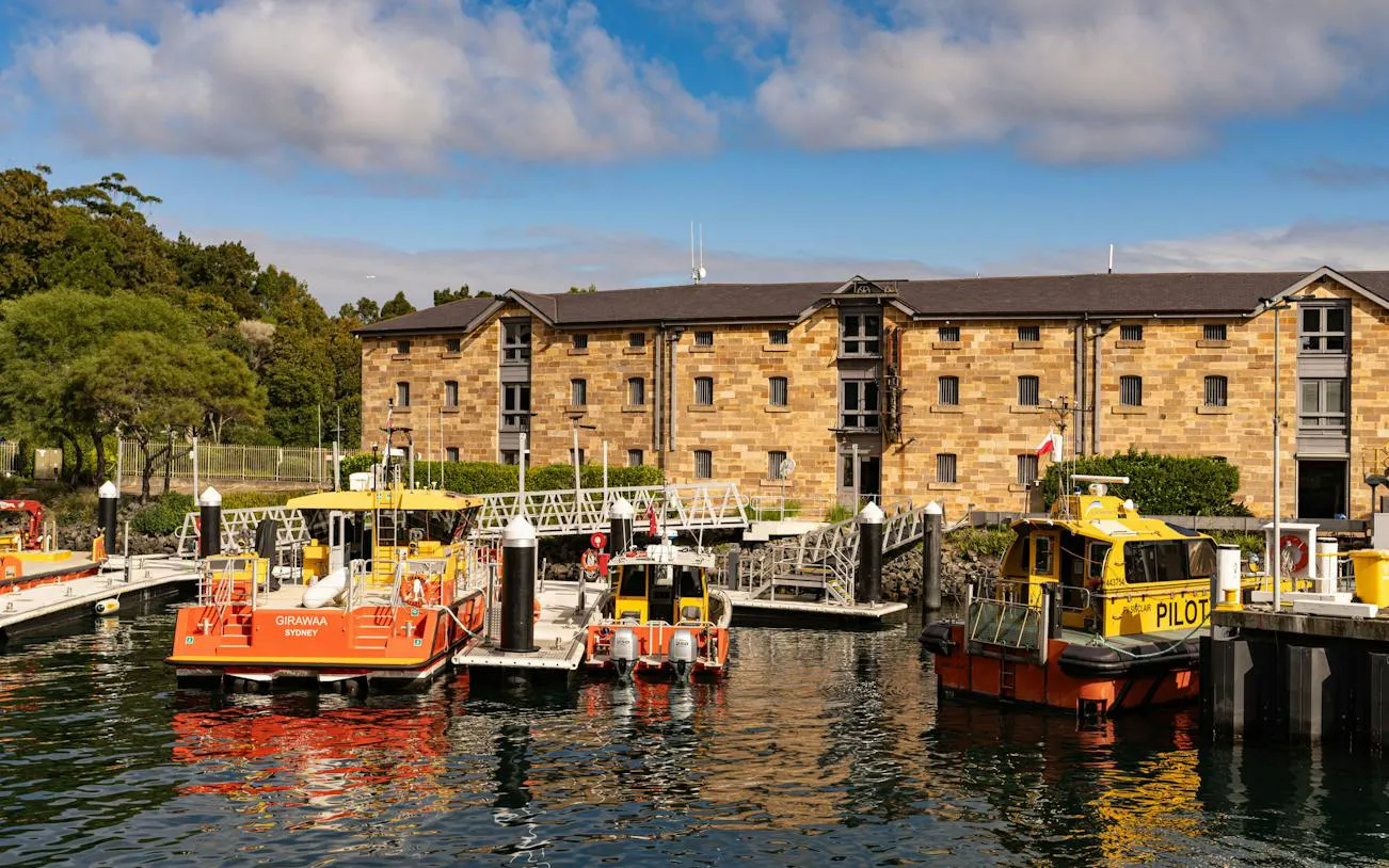 Historic sandstone building and boats at Campbell's Cove, Sydney.