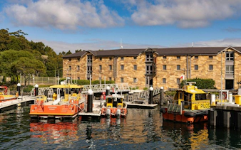 Historic sandstone building and boats at Campbell's Cove, Sydney.