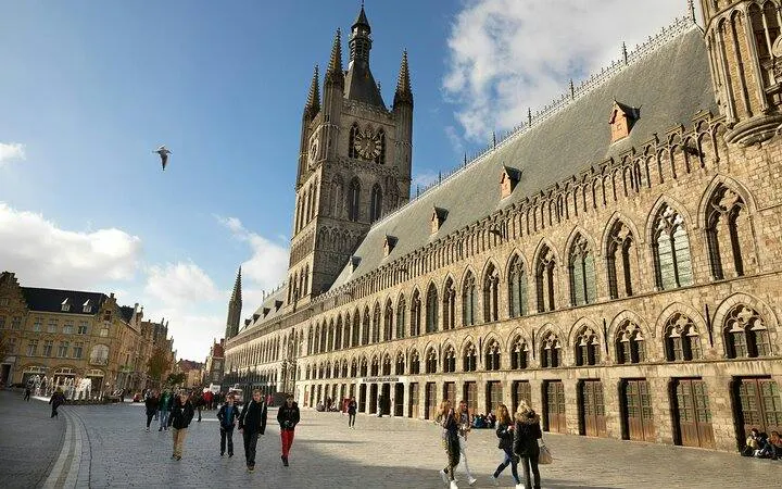 Lakenhalle in Ypres, Belgium, with tourists walking, part of Flanders Fields WWI Remembrance Tour.