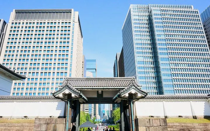 Tokyo Imperial Palace gate with modern skyscrapers in the background.