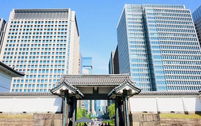 Tokyo Imperial Palace gate with modern skyscrapers in the background.