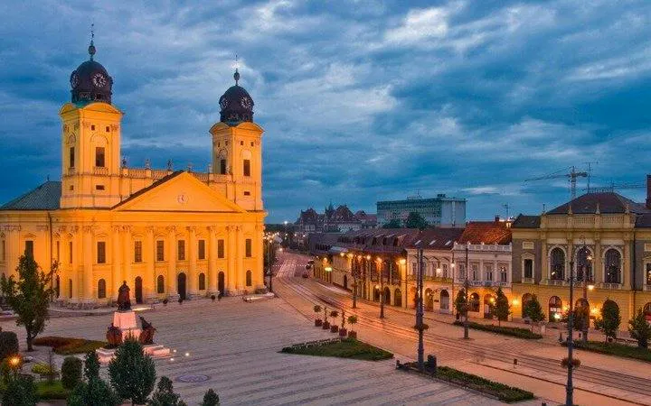 Reformed Great Church in Debrecen at dusk during self-guided audio walking tour.