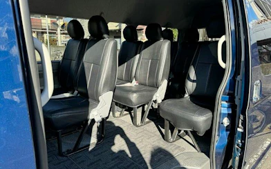Interior of a private car for Tokyo airport transfer, showing spacious seating arrangement.