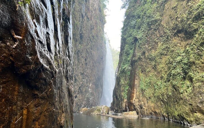Dragon Waterfall in Sapa with lush cliffs and flowing water.