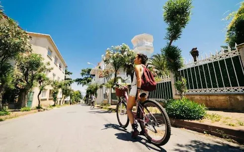 Cyclist exploring Heybeliada street on Princess Islands ferry tour.