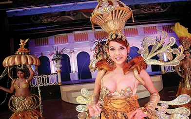 Golden Dome Cabaret performers in elaborate costumes on stage, Bangkok.