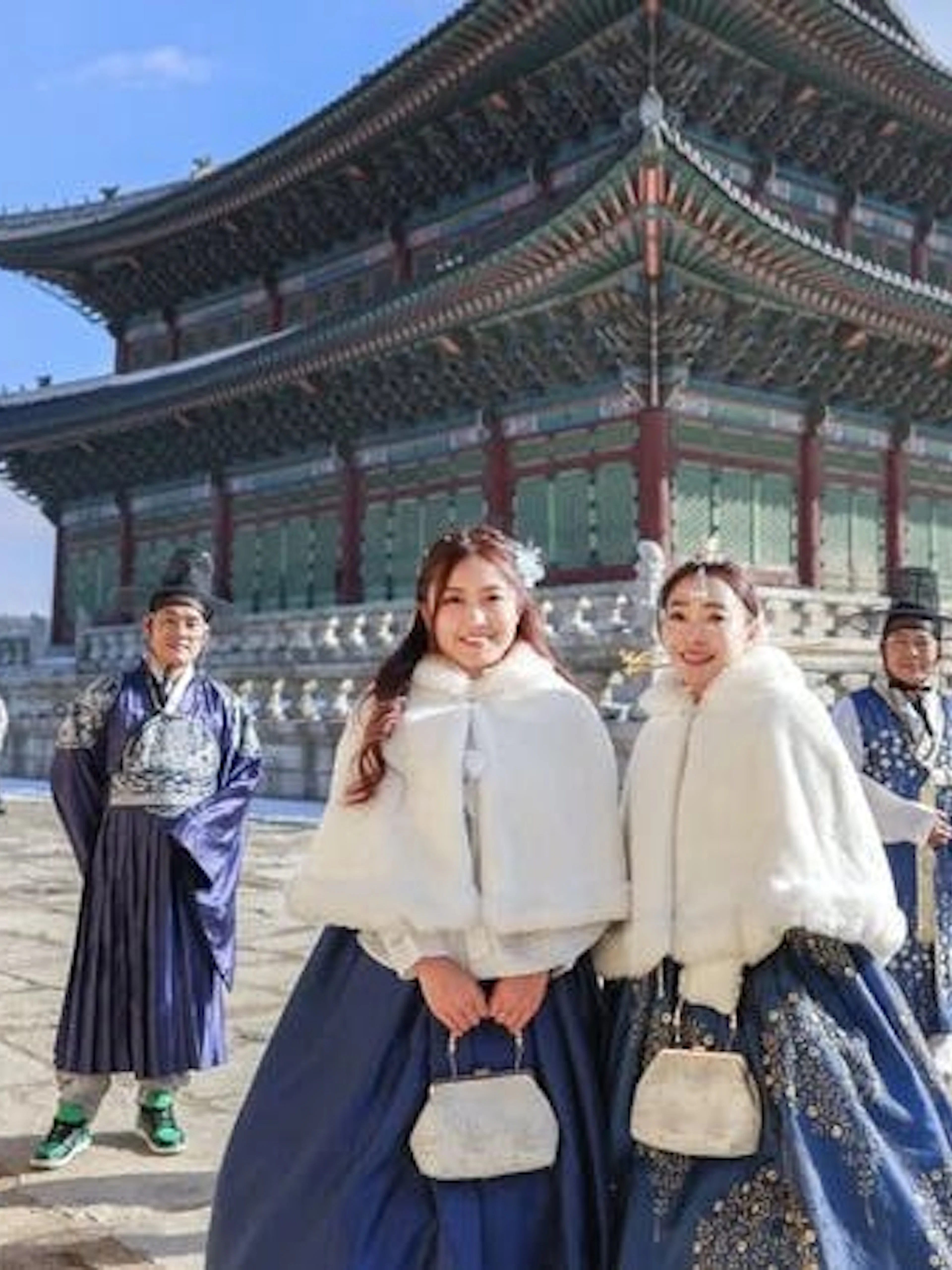 Visitors in traditional hanbok attire at Gyeongbokgung Palace, Seoul, during a professional photoshoot.