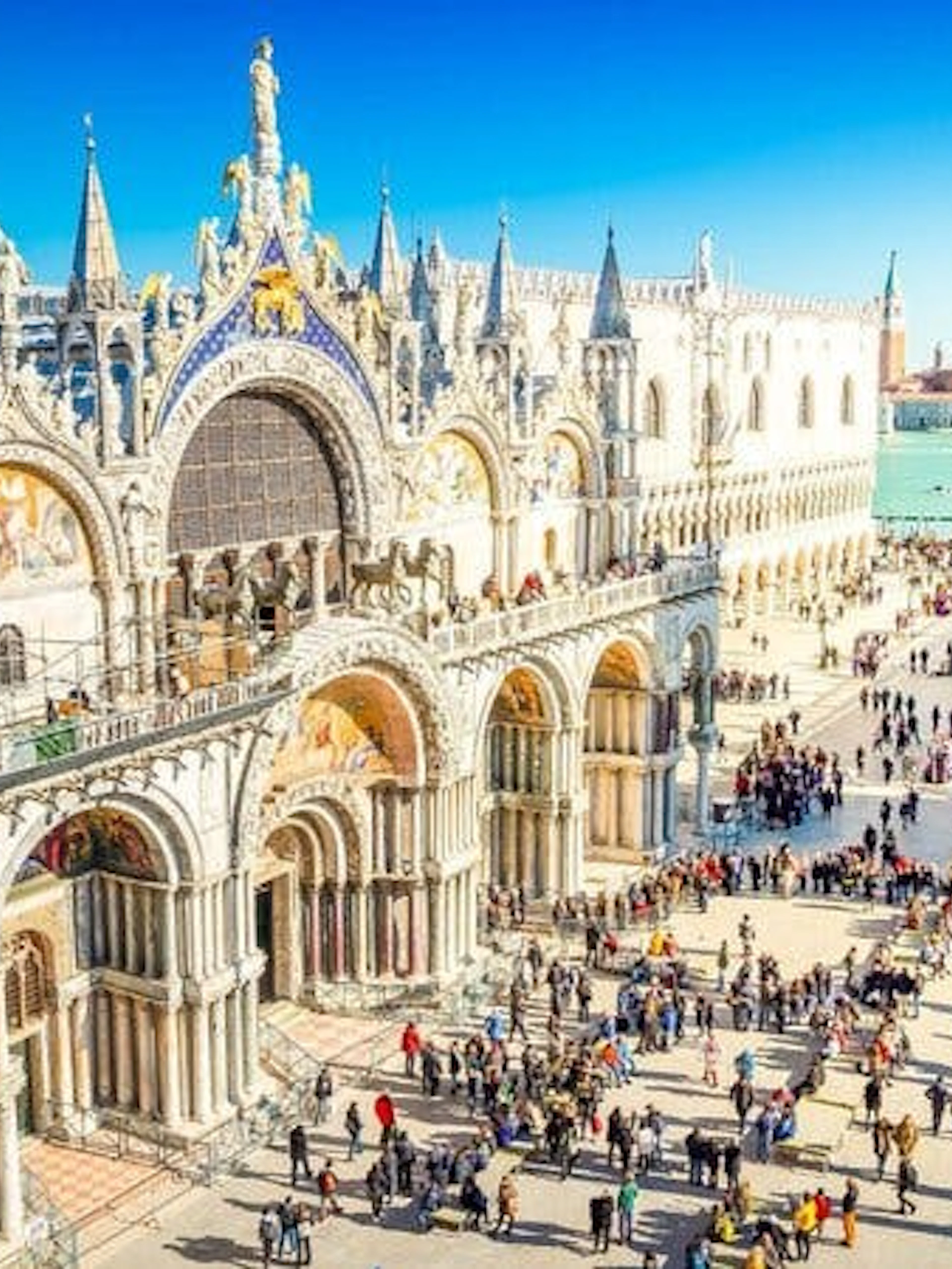 St. Mark's Basilica and Square bustling with tourists in Venice during a self-guided walking tour.