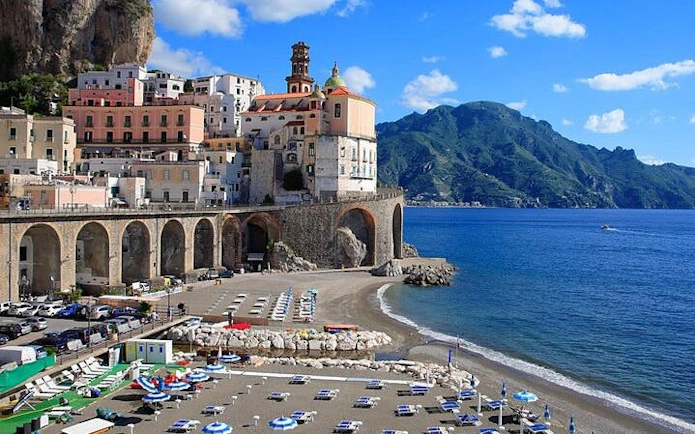 Amalfi Coast cliffside village with beach and sea view, Italy.