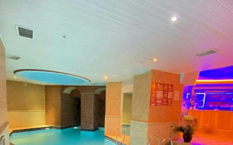 Indoor pool area at Istanbul Turkish Bath with brick walls and ambient lighting.