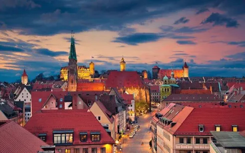 Nuremberg cityscape at sunset with historic buildings and castle, view from self-guided walking tour.