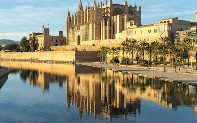 Palma Cathedral reflected in water during a self-guided walking tour in Palma de Mallorca.