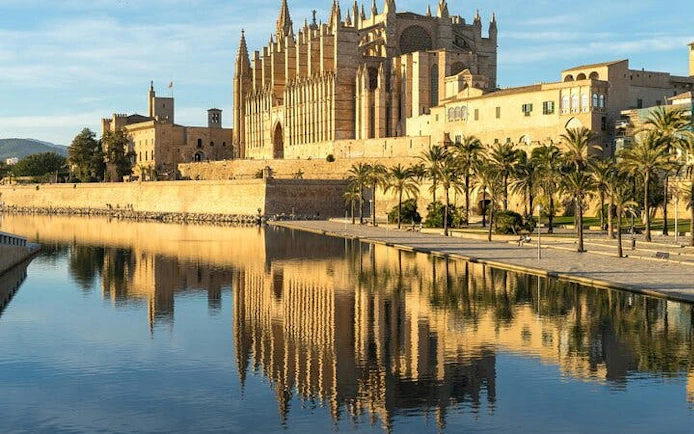 Palma Cathedral reflected in water during a self-guided walking tour in Palma de Mallorca.