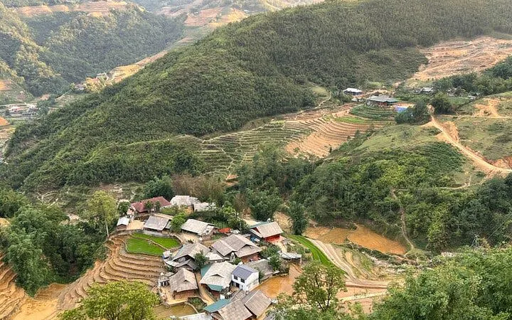 Sapa village and terraced rice fields viewed from above, showcasing lush green hills.