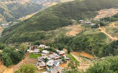 Sapa village and terraced rice fields viewed from above, showcasing lush green hills.