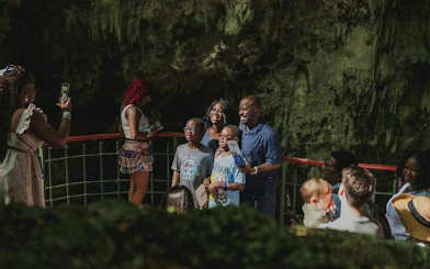 Group of tourists posing for a photo inside a cave during Santo Domingo day tour from Punta Cana.