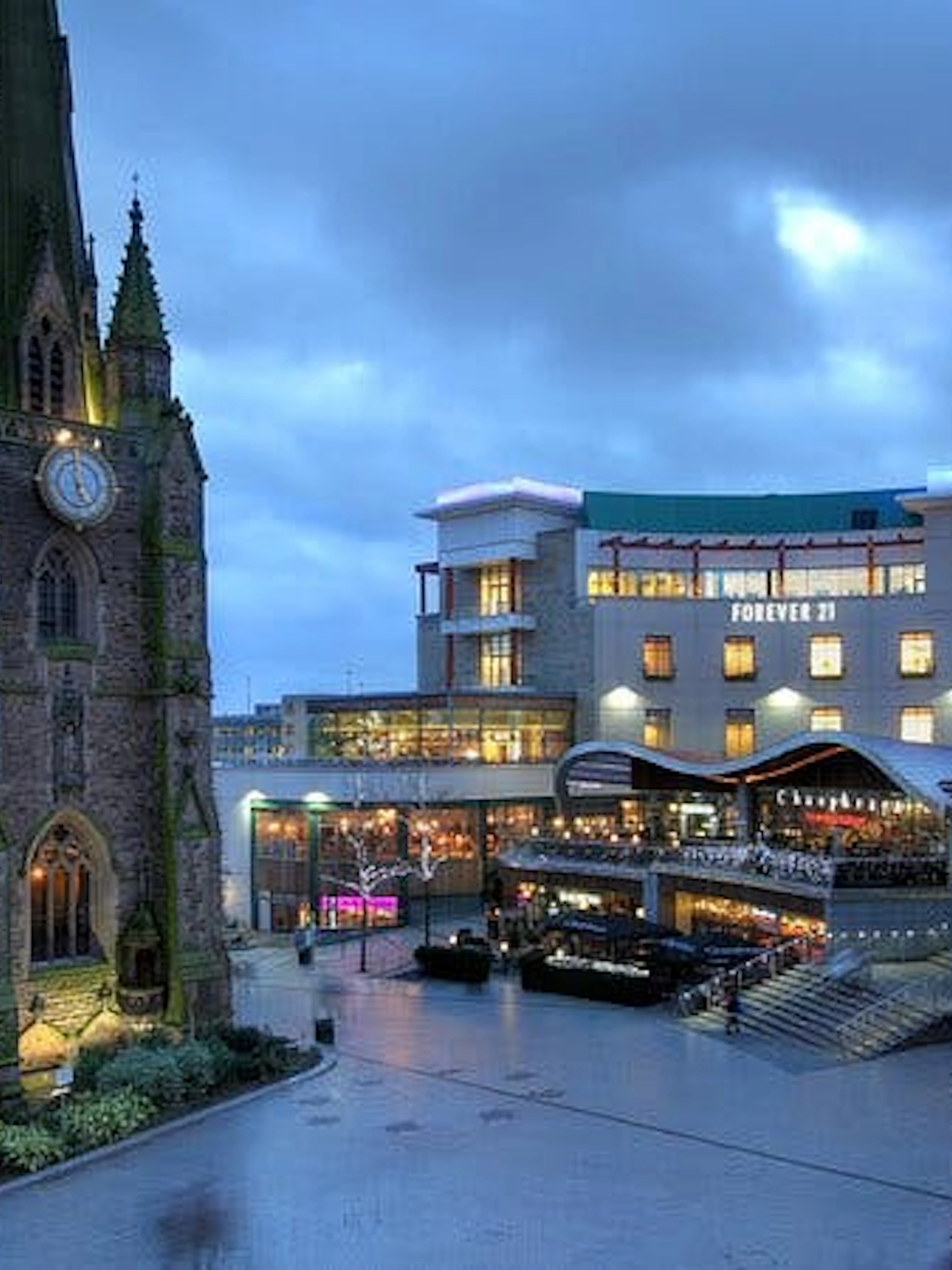 St. Martin's Church and Bullring shopping center in Birmingham at dusk.