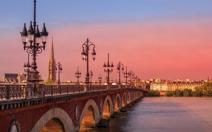 Pont de Pierre bridge over Garonne River at sunset, Bordeaux.