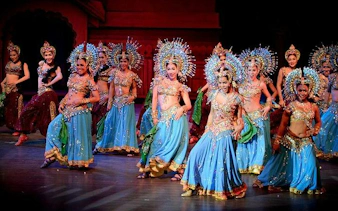 Performers in vibrant costumes dancing at Colosseum Show Pattaya, Thailand.