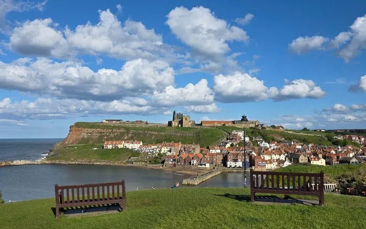 Whitby Abbey overlooking coastal town and harbor, part of York's Castles, Coasts, and Gothic Legends tour.