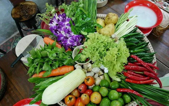 Fresh ingredients for Thai cooking class at Baan Hongnual, Chiang Mai, including herbs and vegetables.