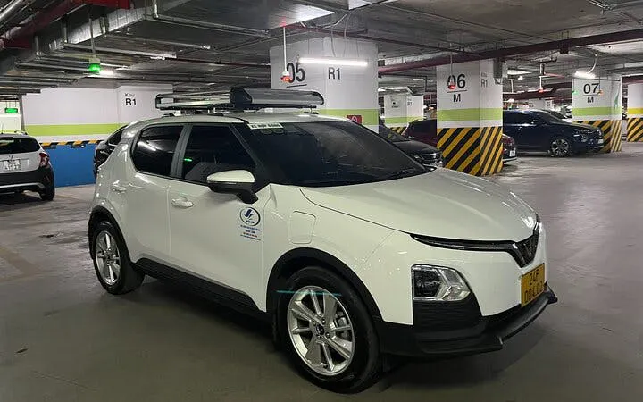 Private transfer vehicle in parking garage for Sapa to Lào Cai Train Station route.