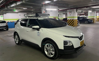 Private transfer vehicle in parking garage for Sapa to Lào Cai Train Station route.