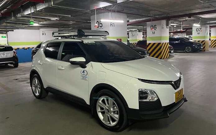 Private transfer vehicle in parking garage for Sapa to Lào Cai Train Station route.