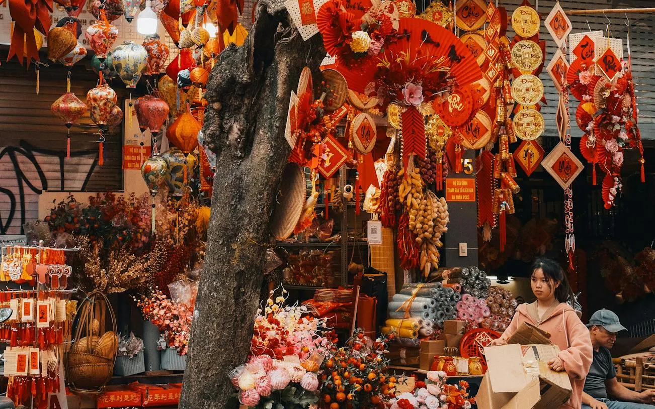 Hanoi Old Quarter street market with colorful lanterns and decorations for sale.