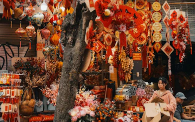 Hanoi Old Quarter street market with colorful lanterns and decorations for sale.