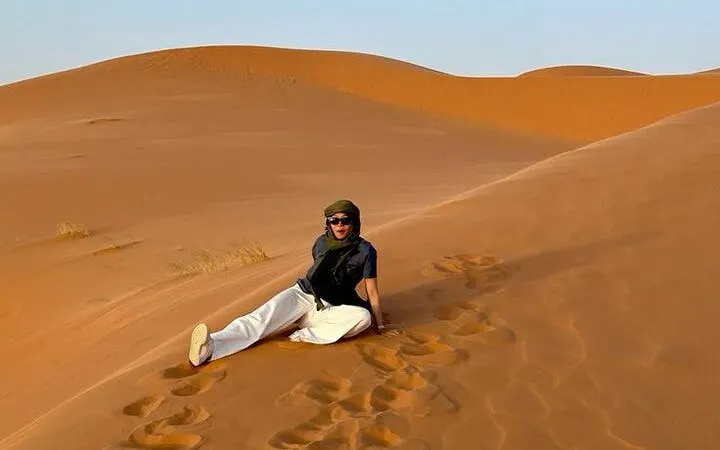 Person sitting on sand dune during Zagora Overnight Desert Adventure, Marrakech.