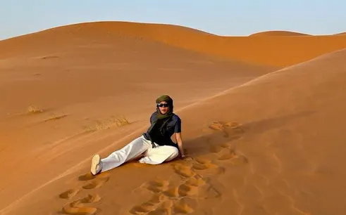 Person sitting on sand dune during Zagora Overnight Desert Adventure, Marrakech.