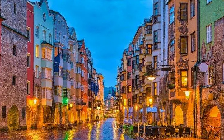 Colorful buildings lining a cobblestone street in Innsbruck during a self-guided walking tour.