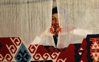 Weaver creating traditional Turkish carpet in Cappadocia.