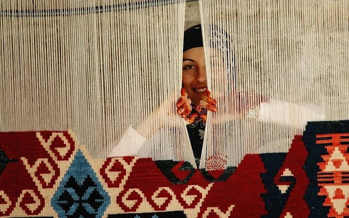 Weaver creating traditional Turkish carpet in Cappadocia.